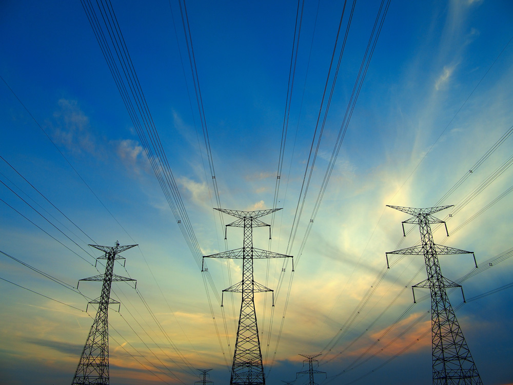 Electric post in a field and blue sky